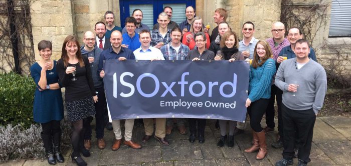 Staff outside the chapel at IS Oxford, celebrating becoming an Employee Owned Trust